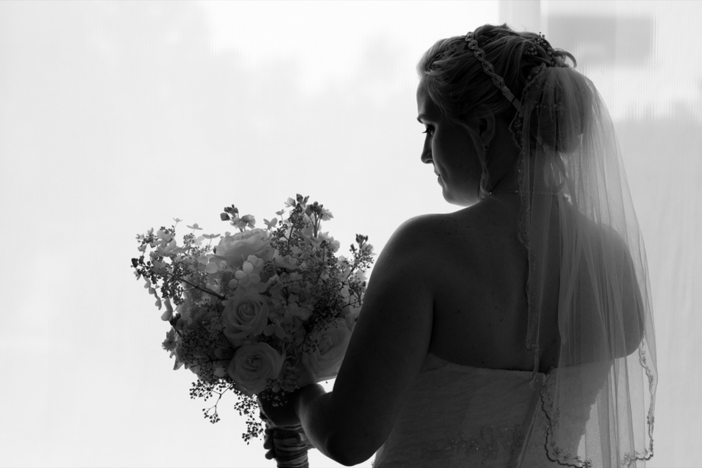 Bride with her bouquet in silhouette