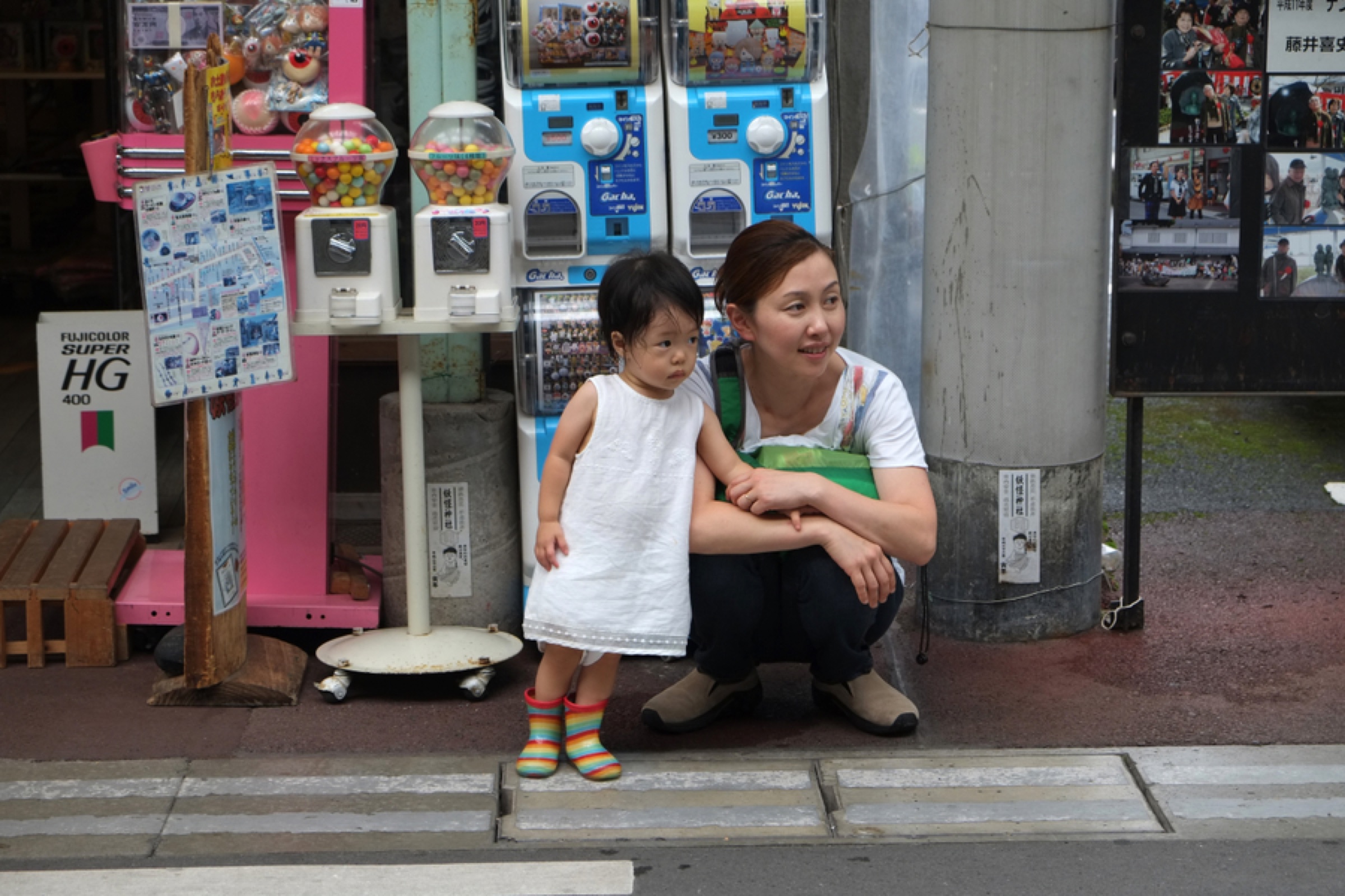 Parent and child outside a shop in Japan