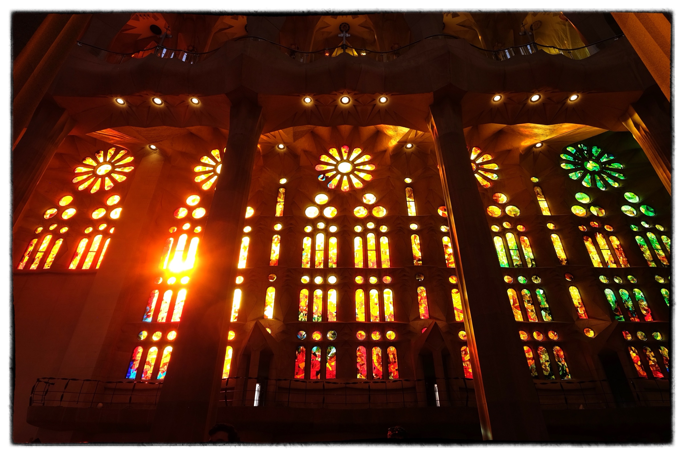 Stained glass glowing inside a basilica