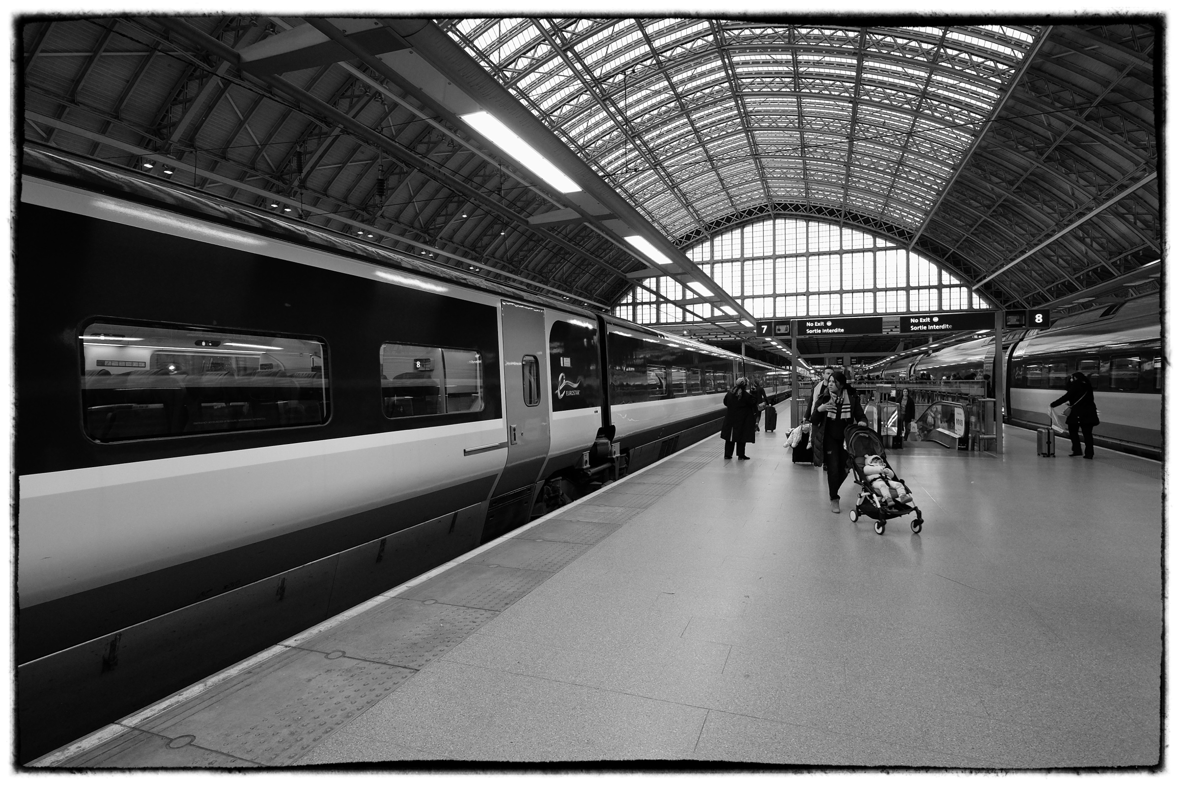 Train waiting under a station roof
